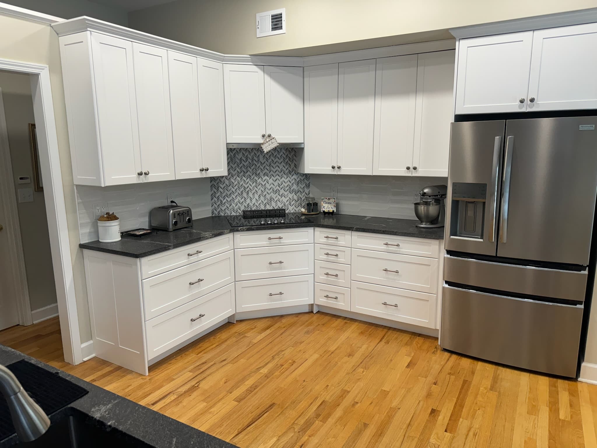 White shaker kitchen with herringbone backsplash